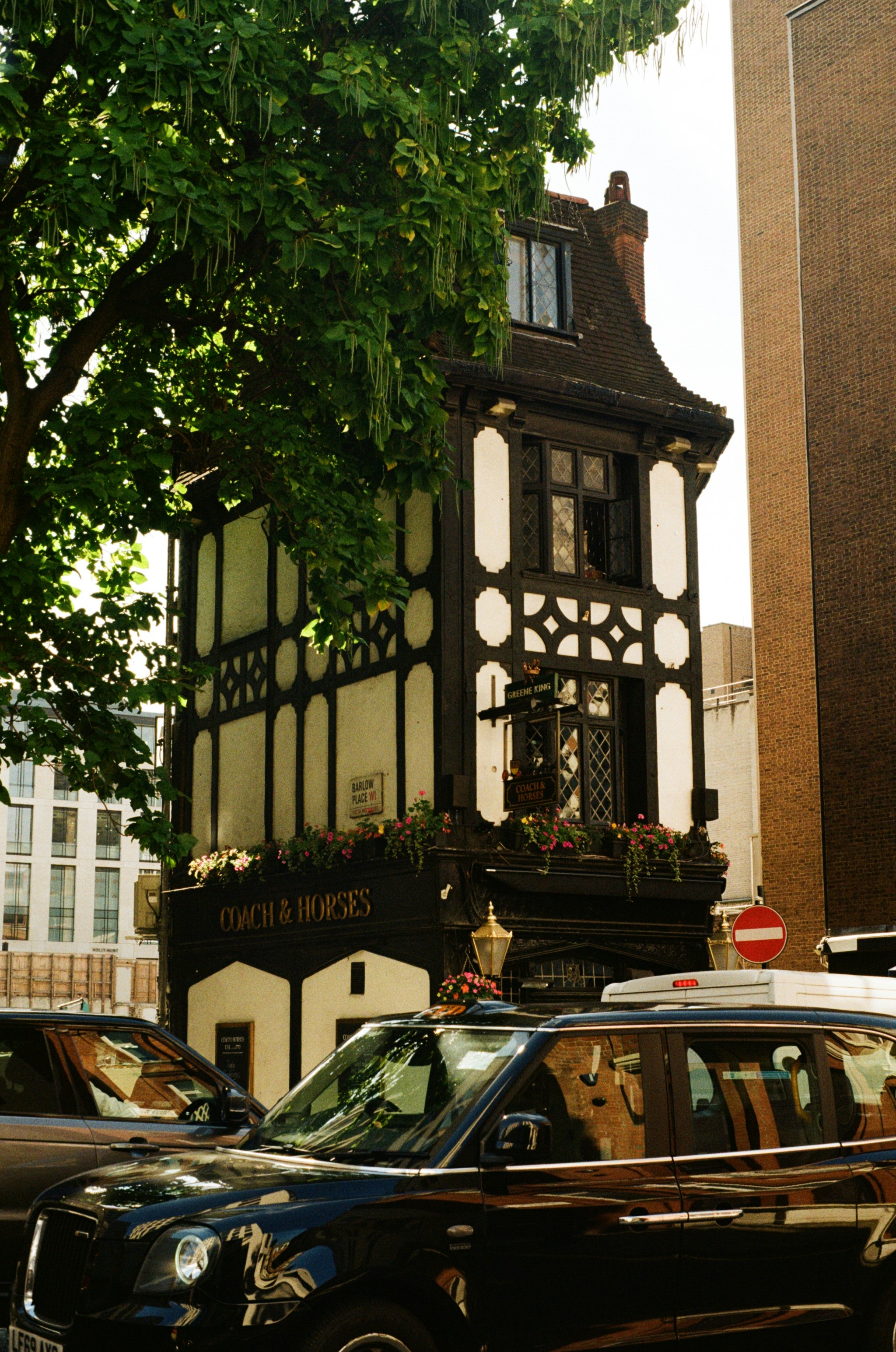 a black car parked in front of a tall building